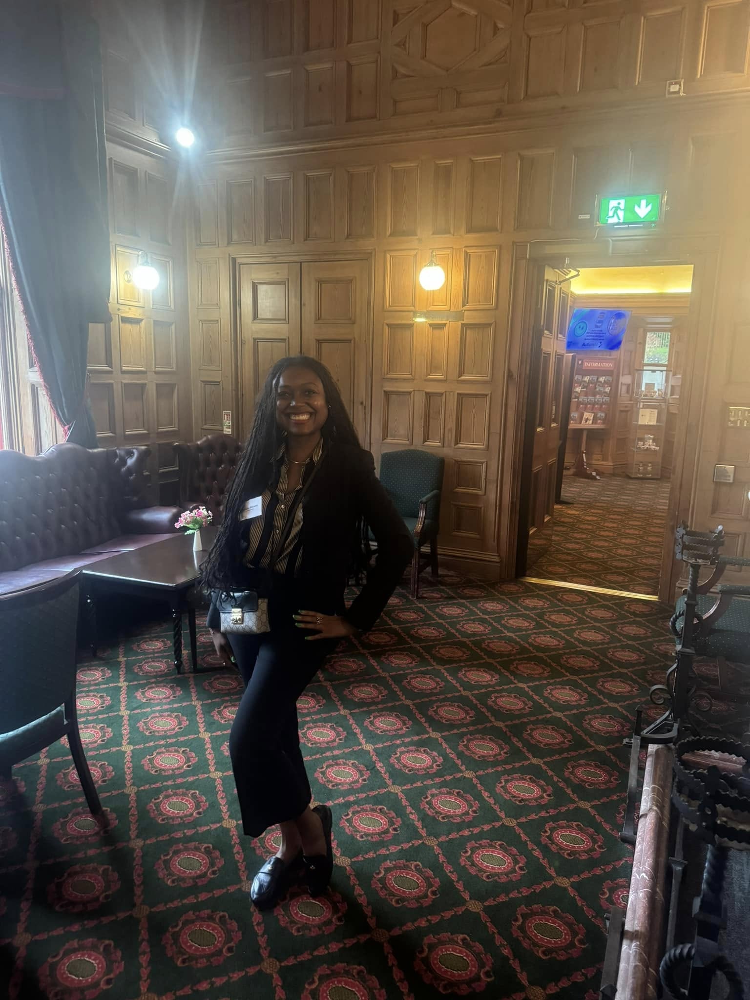 Jessica during her 2024 visit to Belfast, standing in a paneled civic interior